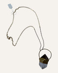 Sculptural crystal pendant necklace with gold-tone geometric setting and mixed metal chain