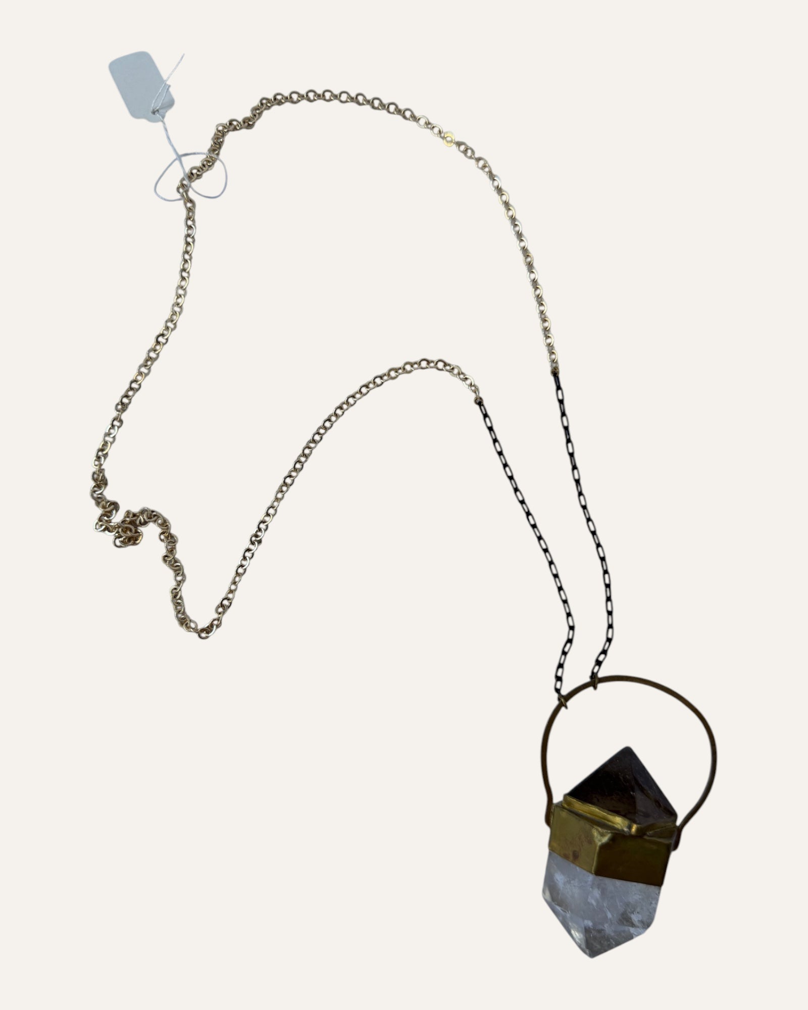 Sculptural crystal pendant necklace with gold-tone geometric setting and mixed metal chain