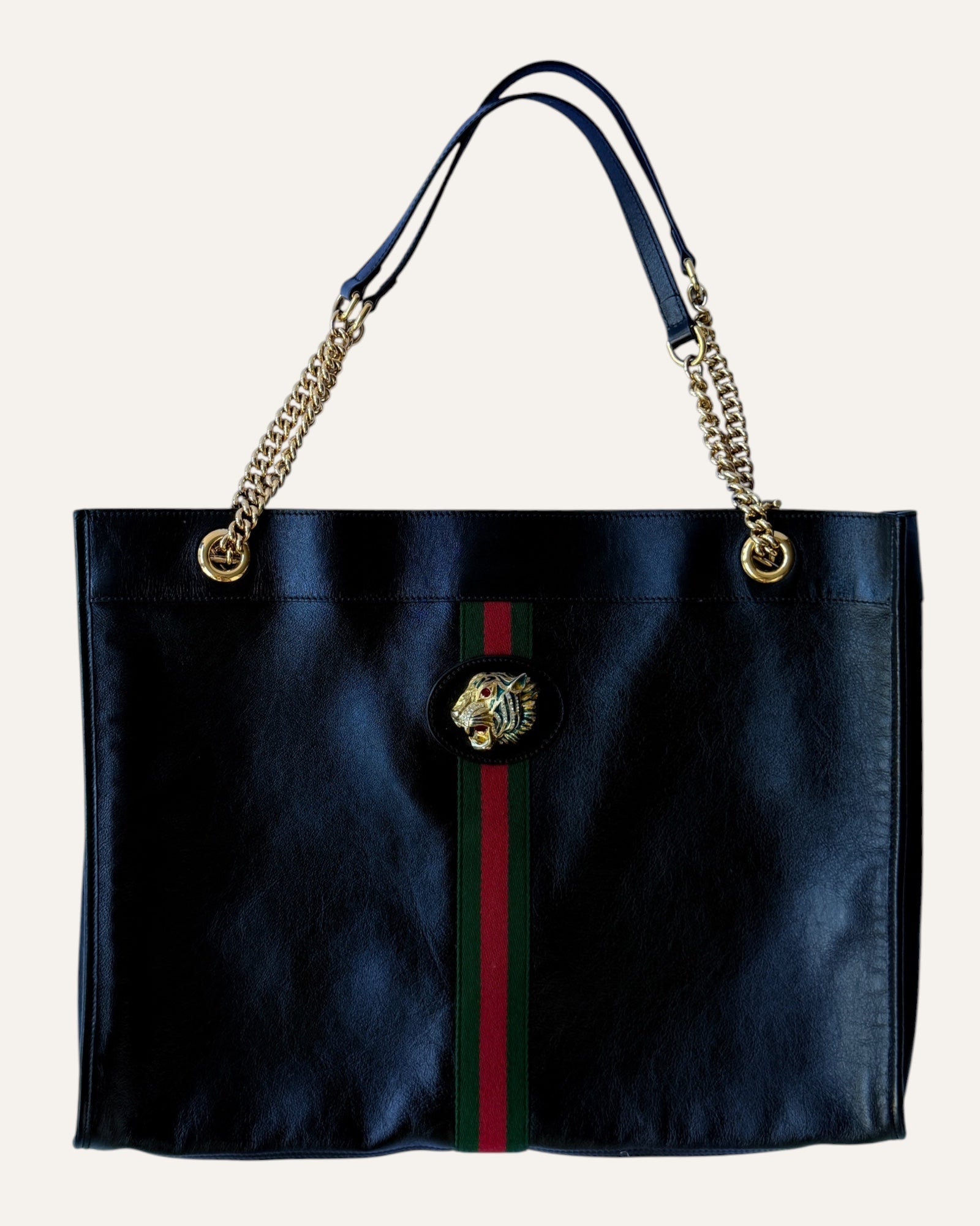 Gucci Rajah large black leather tote with gold chain straps, tiger head hardware, and matching zip pouch