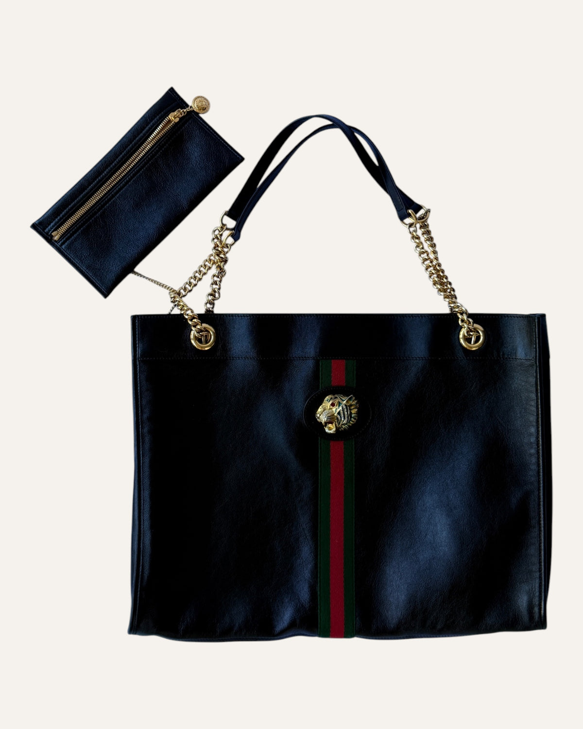 Gucci Rajah large black leather tote with gold chain straps, tiger head hardware, and matching zip pouch