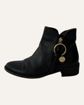See by Chloé black leather moto ankle boot with gold ring zip pull, logo charm, and stacked heel