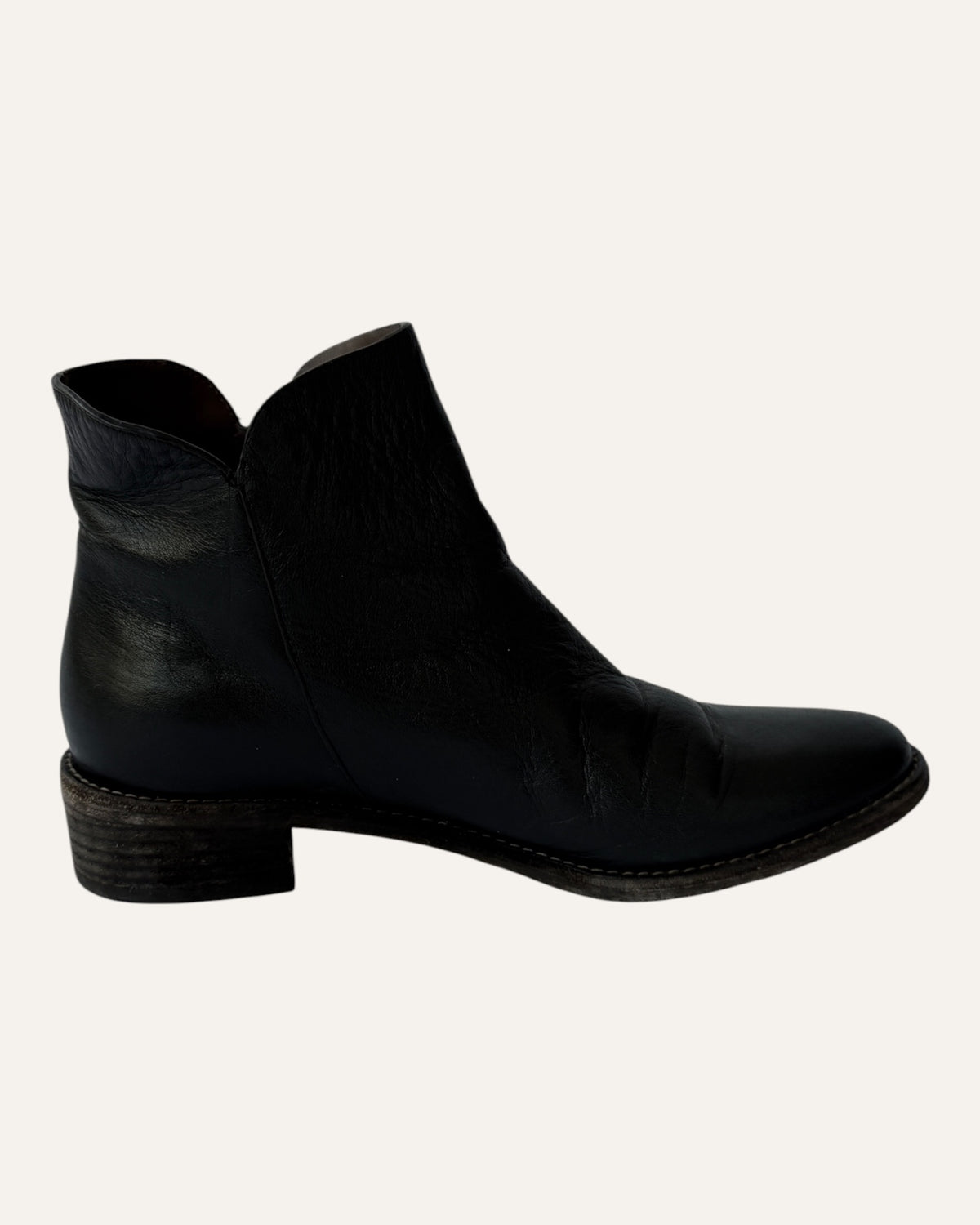 See by Chloé black leather moto ankle boot with gold ring zip pull, logo charm, and stacked heel