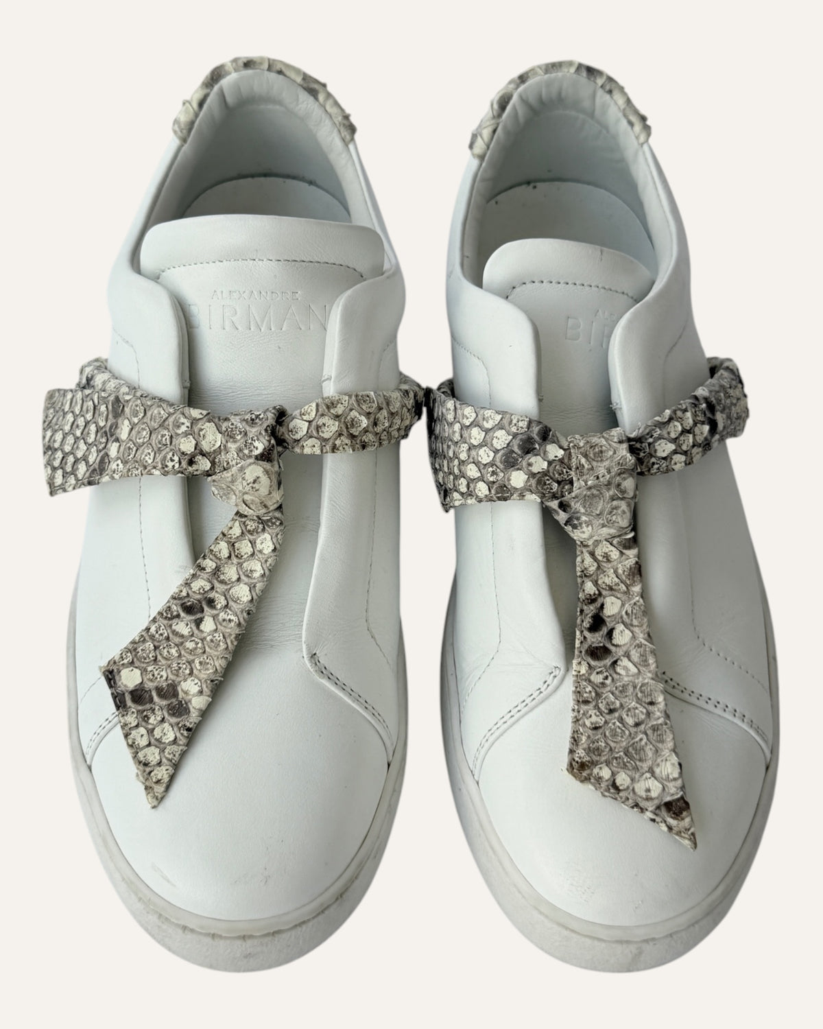 Alexandre Birman white leather slip-on sneakers with knotted jungle snake bow strap