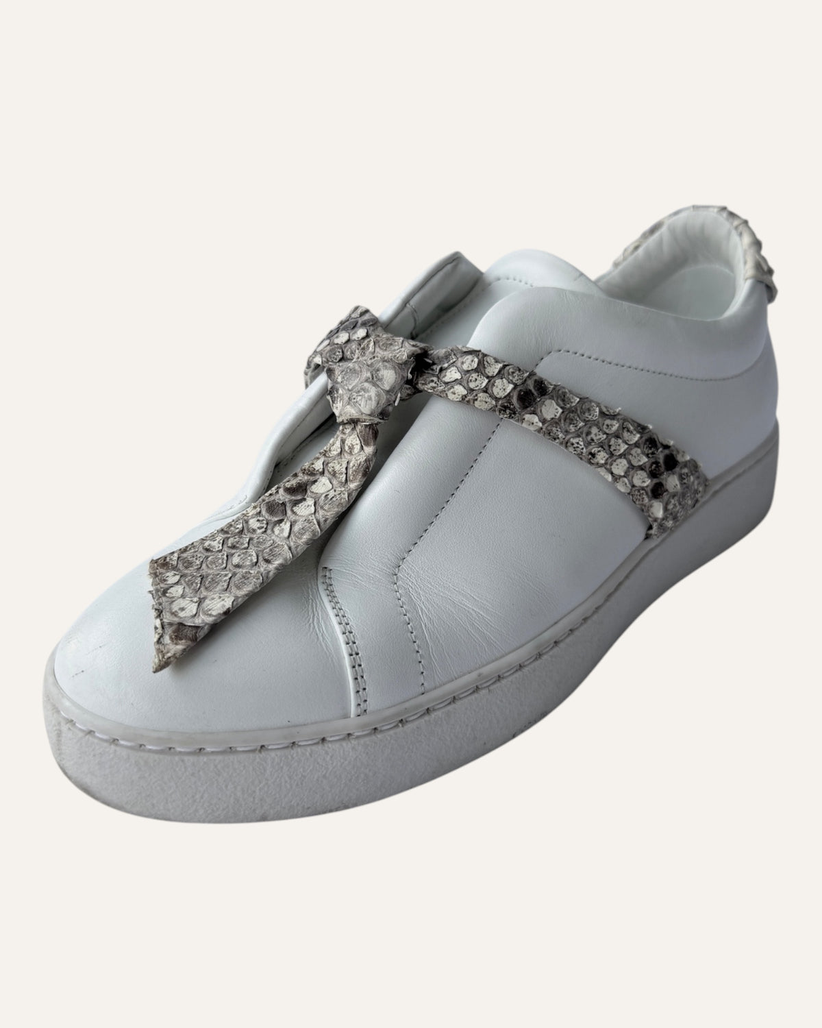 Alexandre Birman white leather slip-on sneakers with knotted jungle snake bow strap