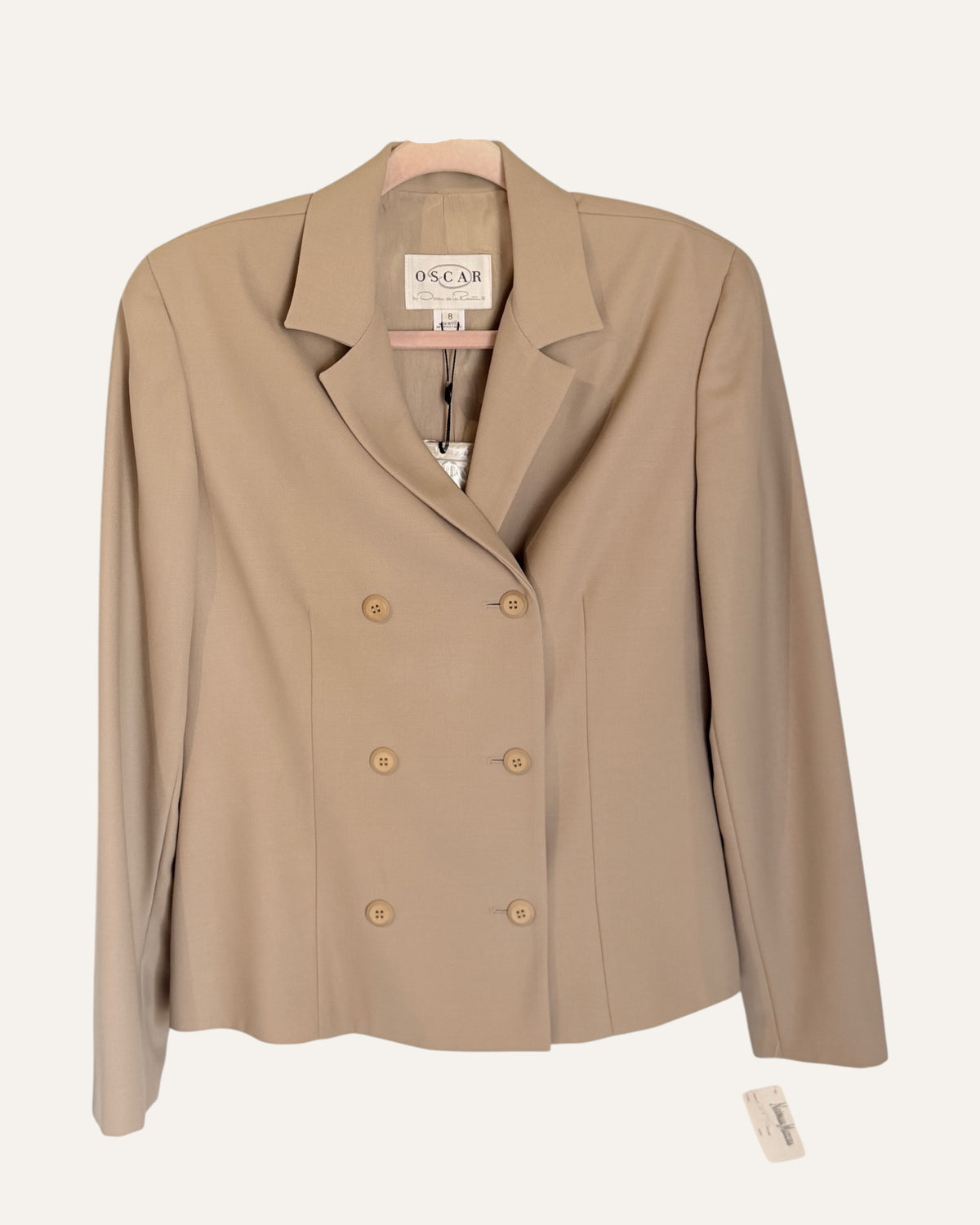 Oscar by Oscar de la Renta camel wool double-breasted blazer and pleated cuffed trousers with Neiman Marcus tags on cream background
