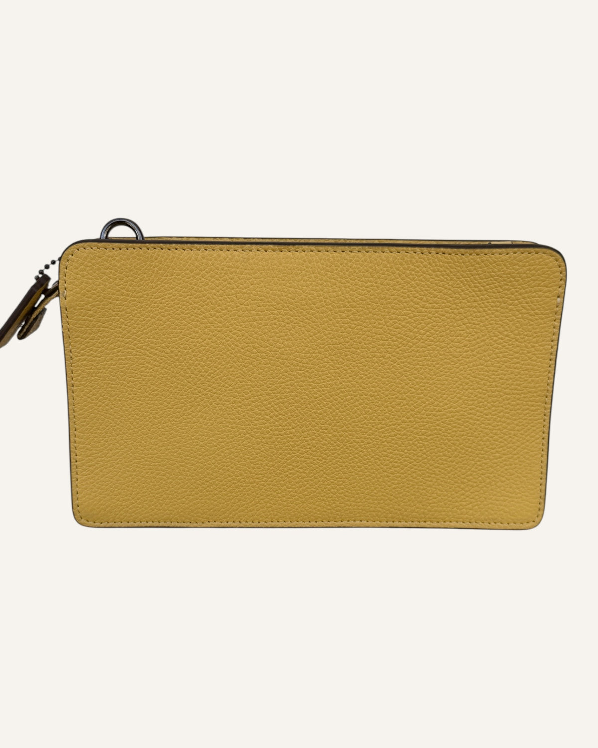 Coach mustard yellow pebbled leather wristlet wallet with snap-tab slip pocket and silver hardware