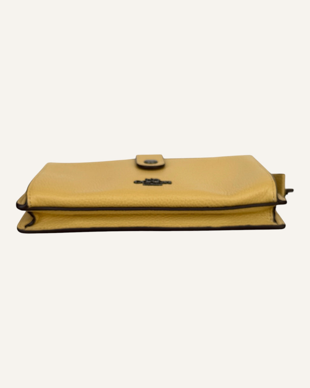 Coach mustard yellow pebbled leather wristlet wallet with snap-tab slip pocket and silver hardware