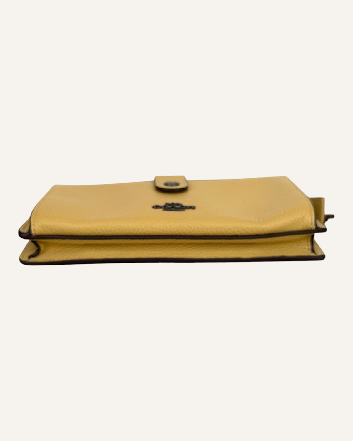 Coach mustard yellow pebbled leather wristlet wallet with snap-tab slip pocket and silver hardware