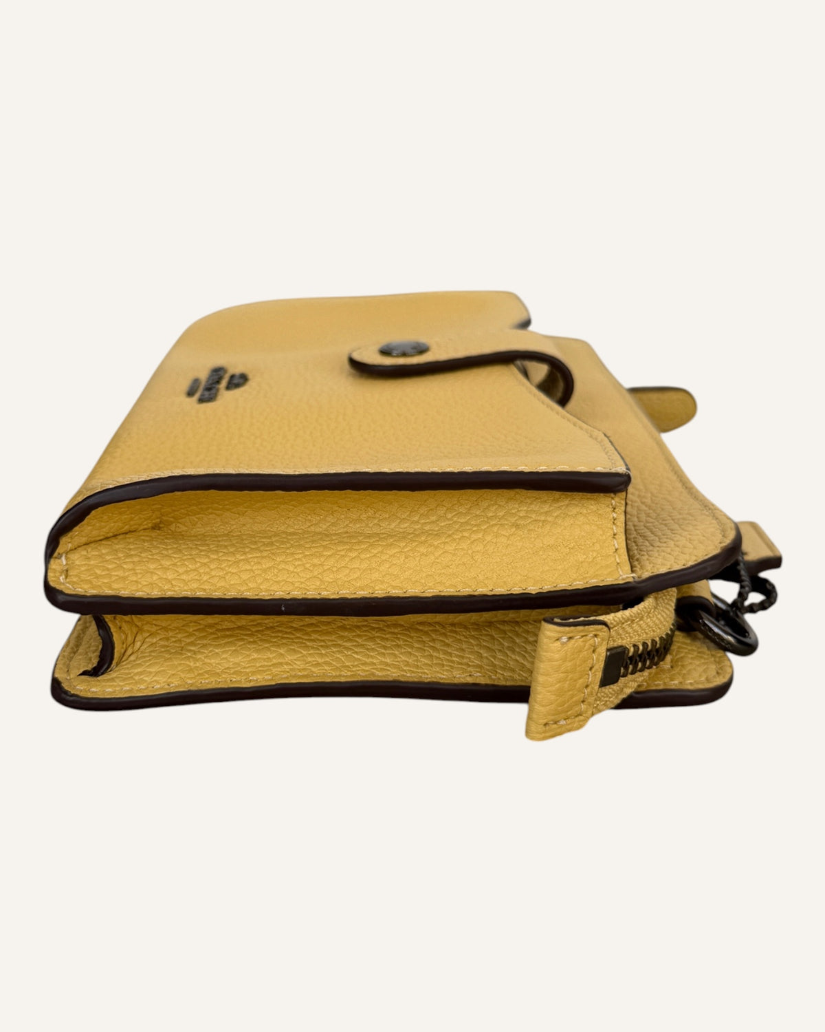 Coach mustard yellow pebbled leather wristlet wallet with snap-tab slip pocket and silver hardware