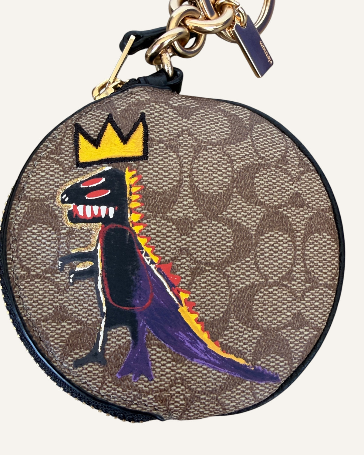 Coach x Jean-Michel Basquiat round coin pouch in brown Signature canvas with crowned Rexy artwork and gold key ring