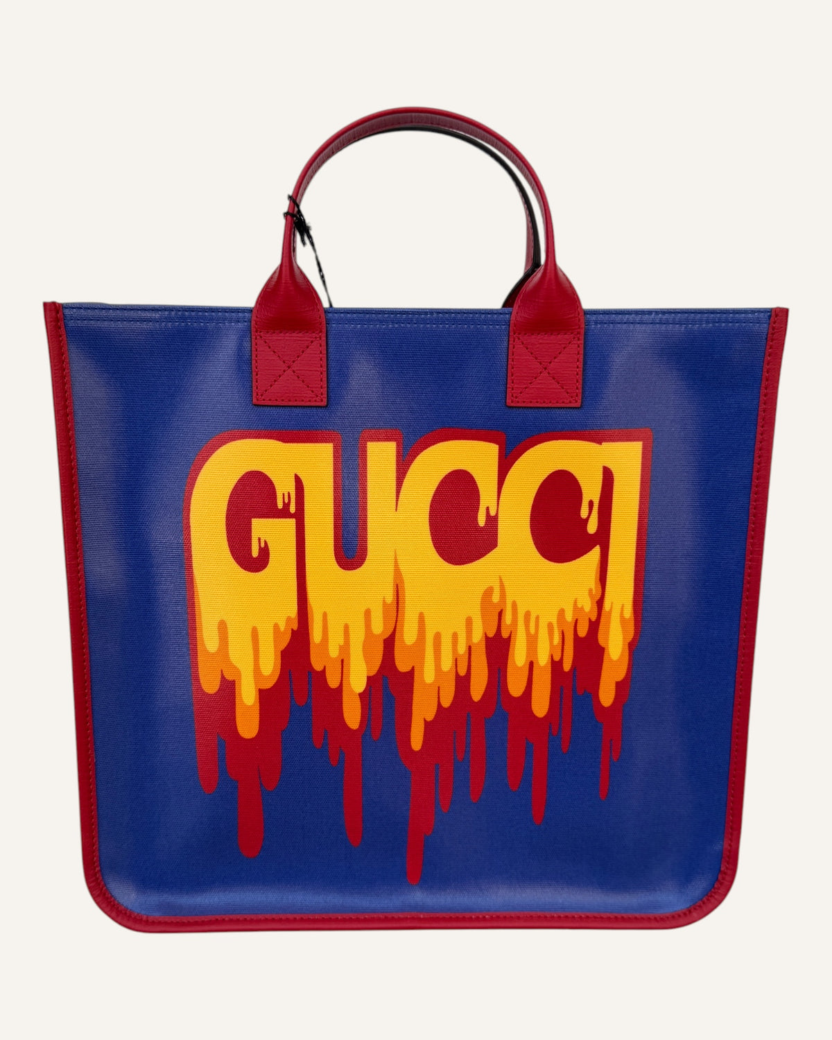 Gucci melting logo tote in royal blue coated canvas with red leather handles and yellow dripping logo print