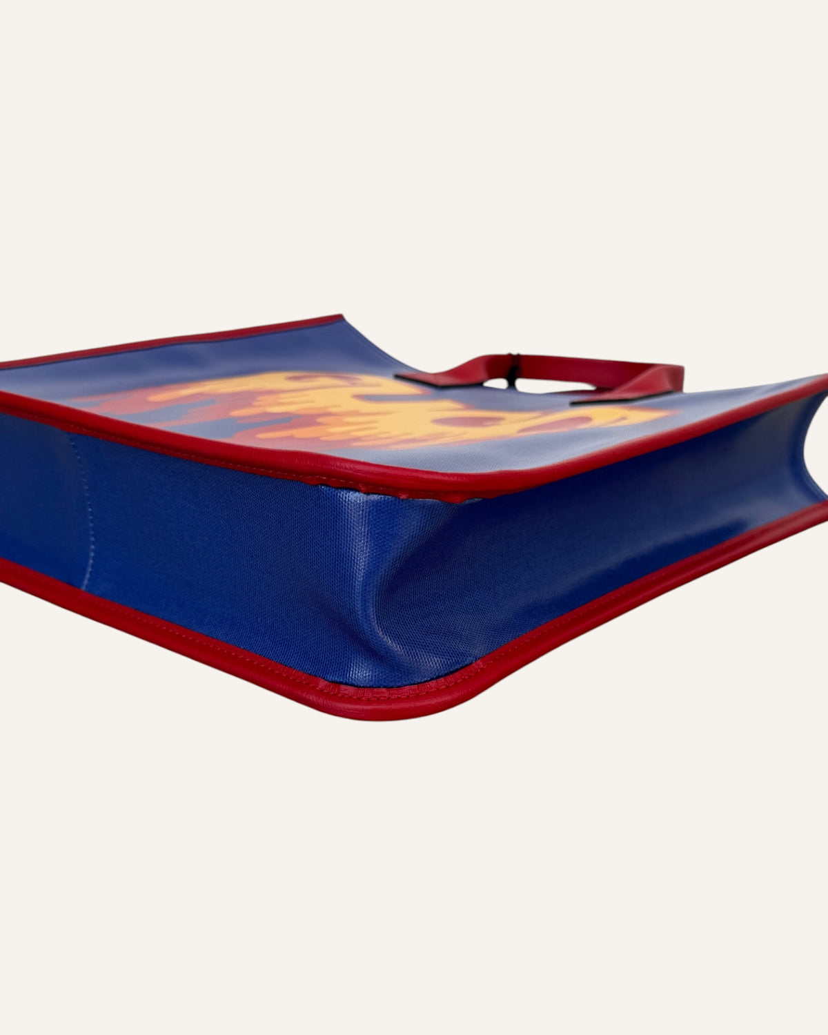 Gucci melting logo tote in royal blue coated canvas with red leather handles and yellow dripping logo print