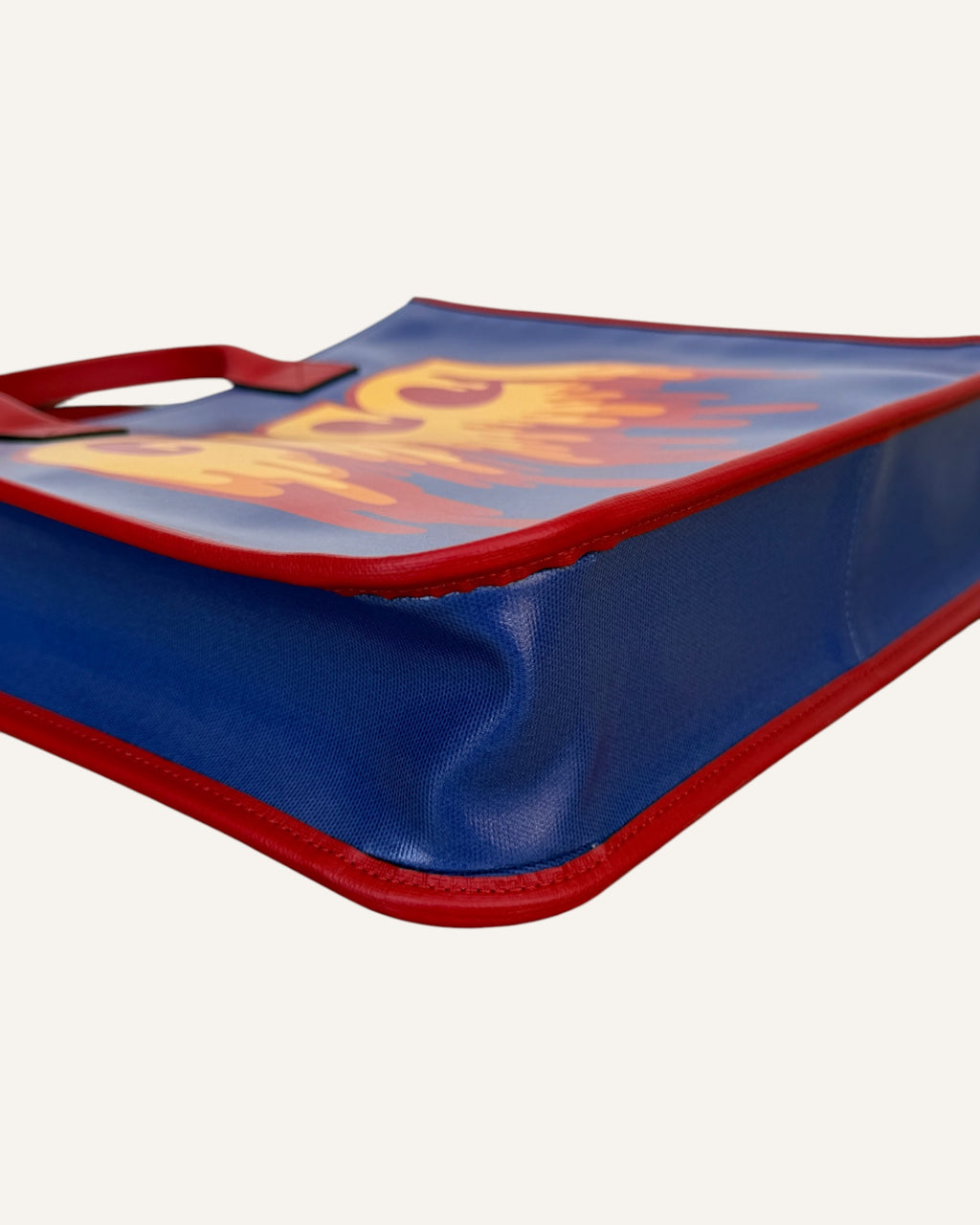 Gucci melting logo tote in royal blue coated canvas with red leather handles and yellow dripping logo print