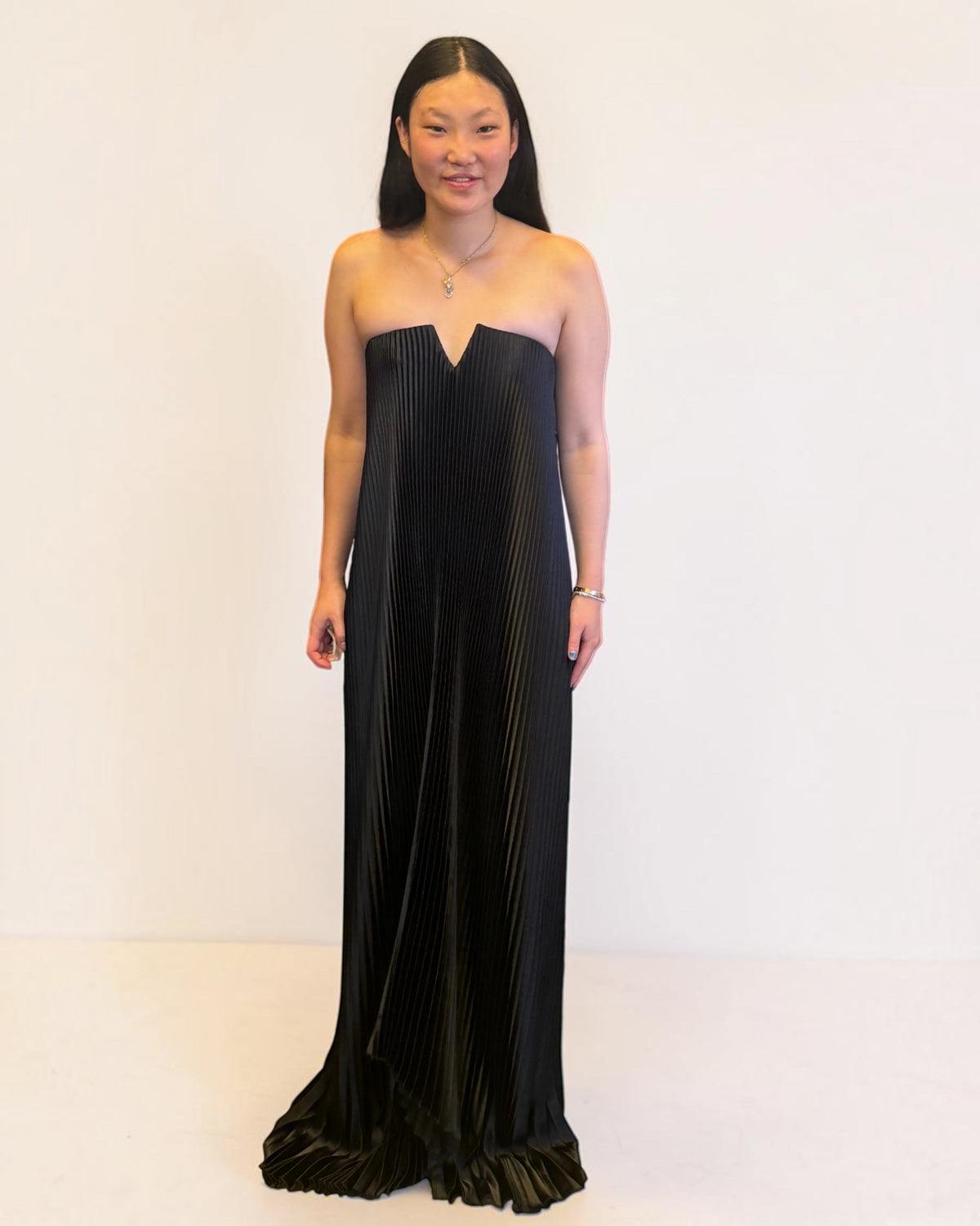 L'idée black pleated strapless gown with notched sweetheart neckline and flounce hem