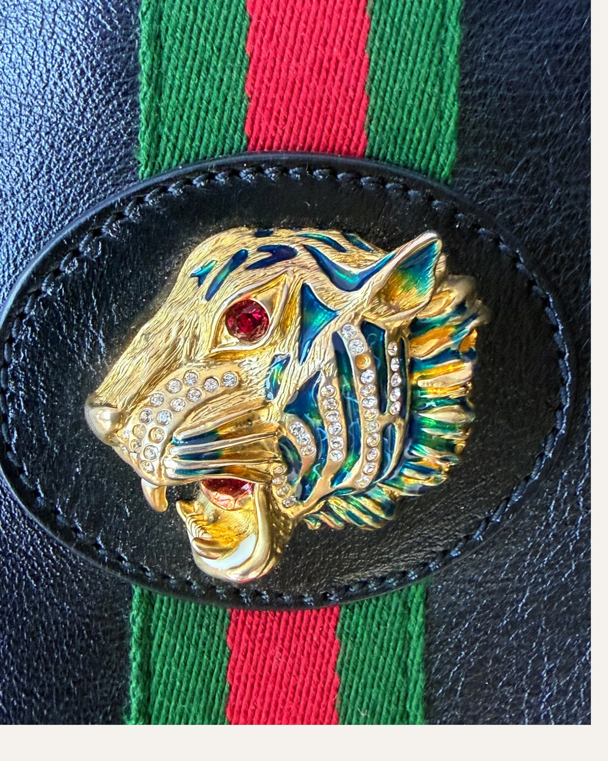 Gucci Rajah large black leather tote with gold chain straps, tiger head hardware, and matching zip pouch